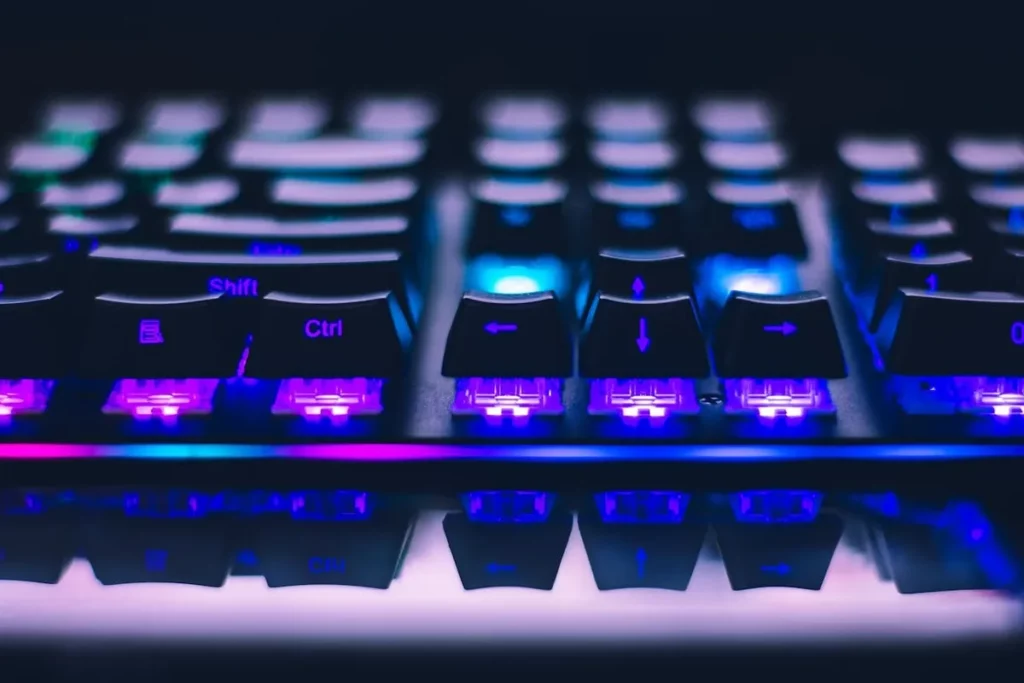 Teclado mecânico iluminado com detalhes dos switches de teclado roxos e azuis, perfeito para gamers e digitação.